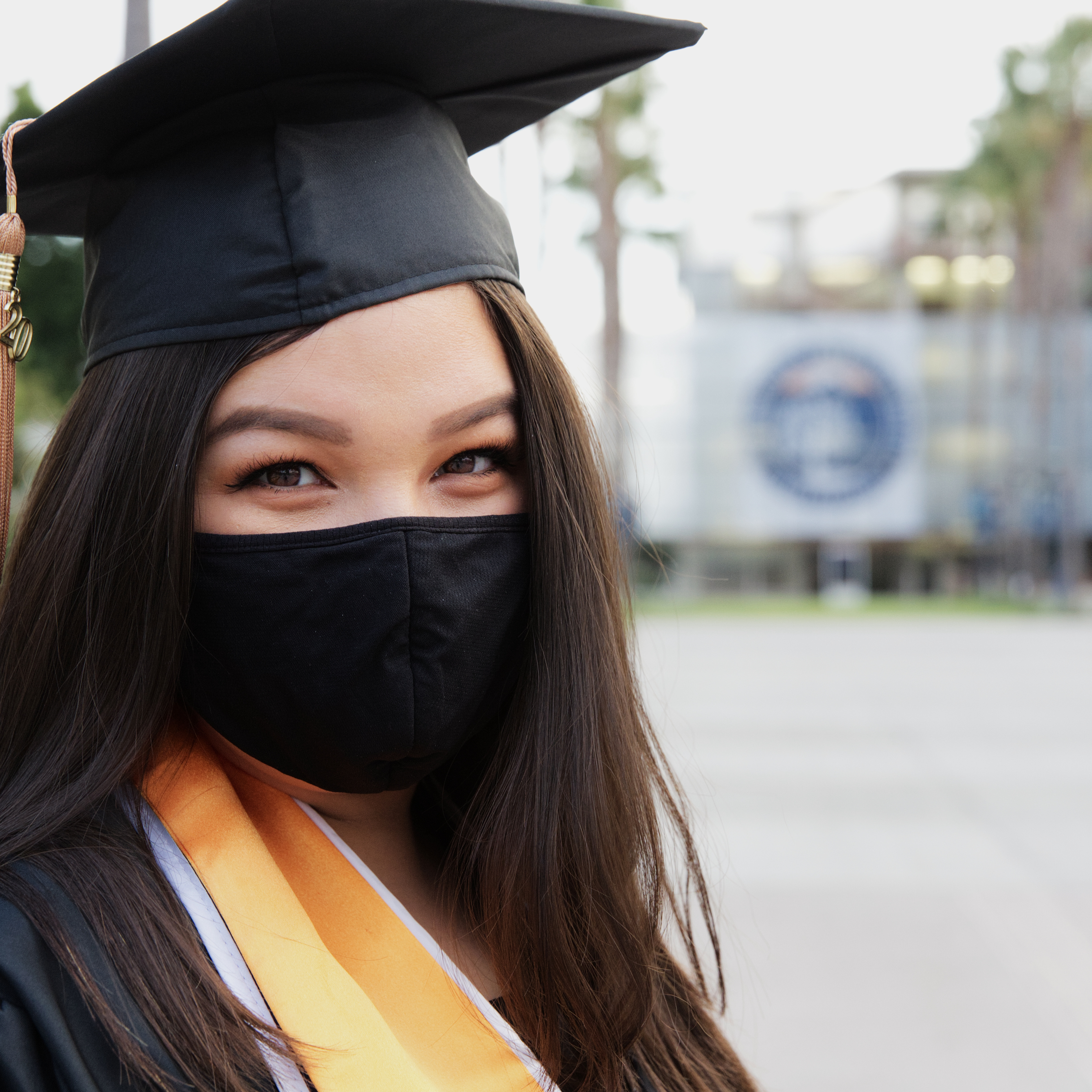 graduation photo close up of girl in a mask