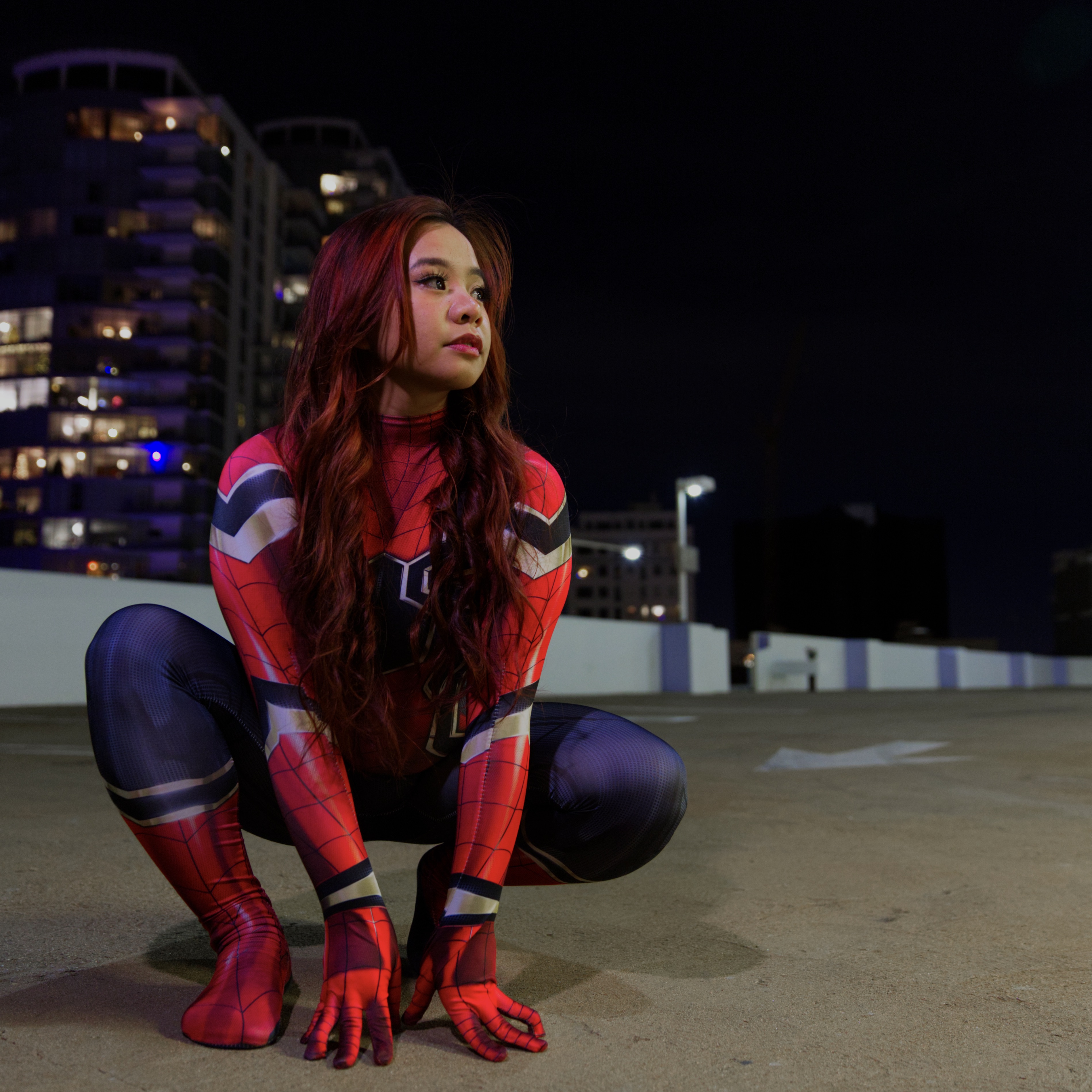 girl dressed up as spiderman in a parkling log